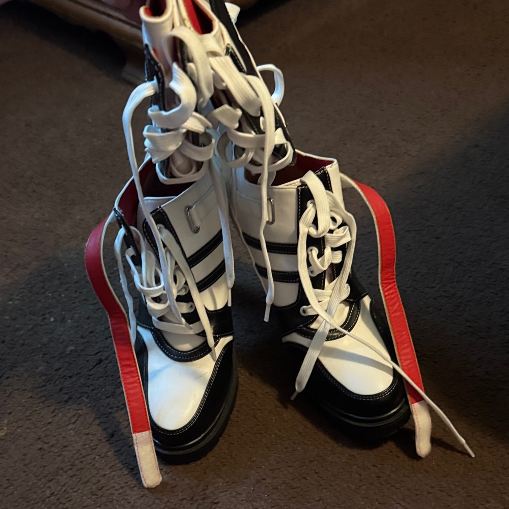 Stylish Black and White Lace-Up Boots with Red Accents
